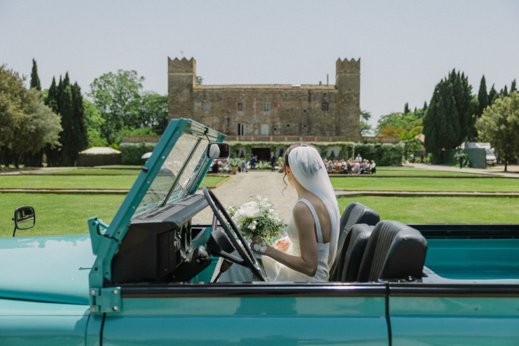 Bride arriving in a Jeep in her wedding in Caramany's castle